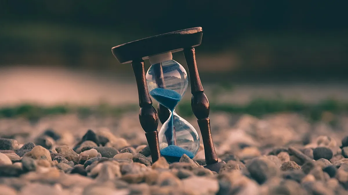 An hourglass standing on stones